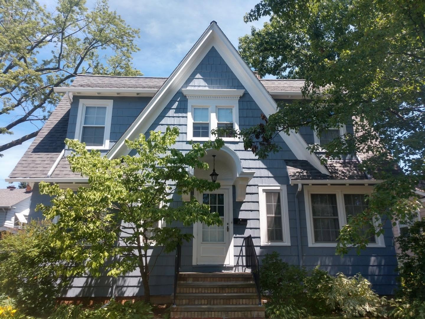 Completed blue-and-white home exterior seen from the front walk