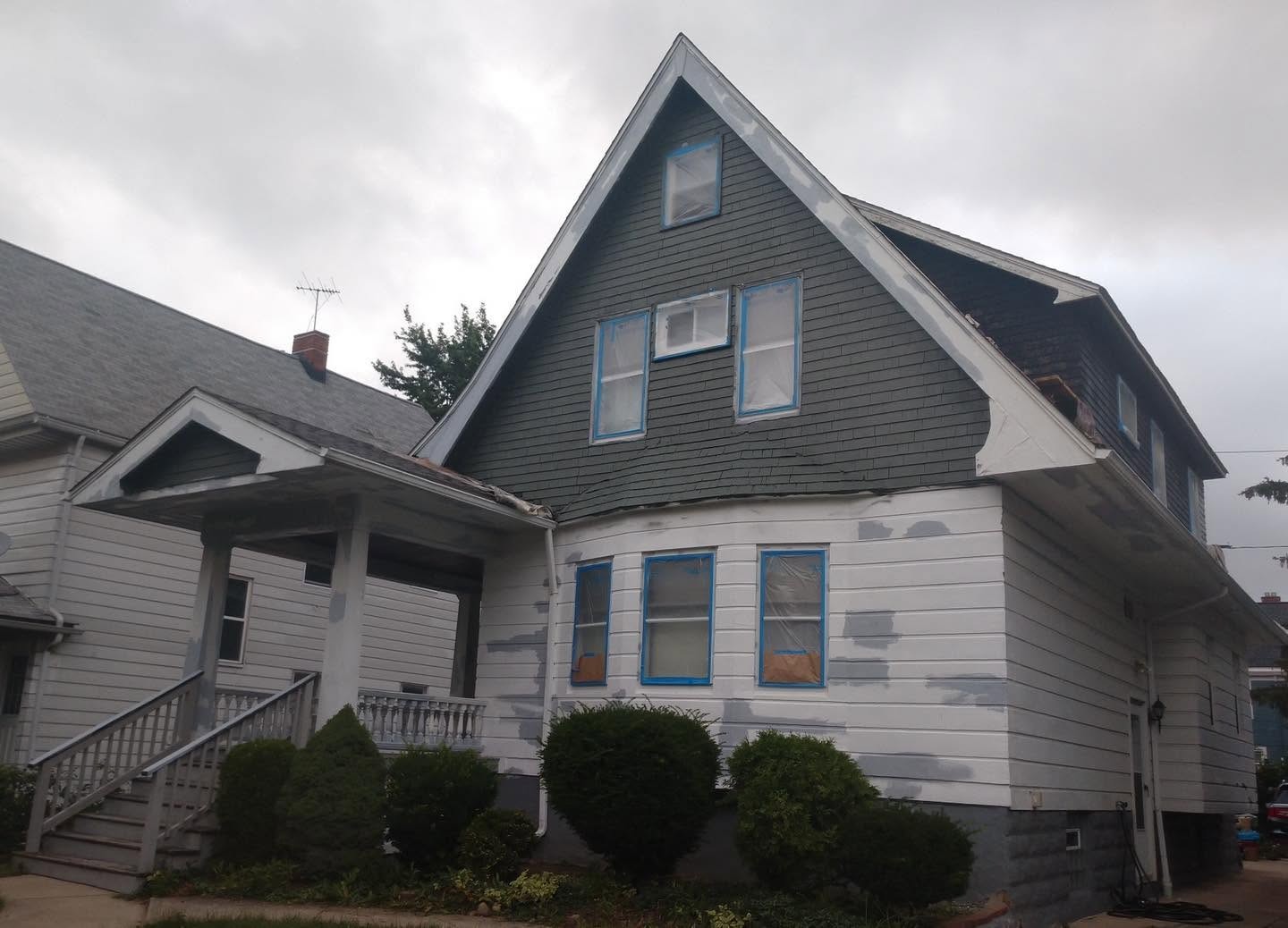 Gabled home exterior during visible patching and preparation