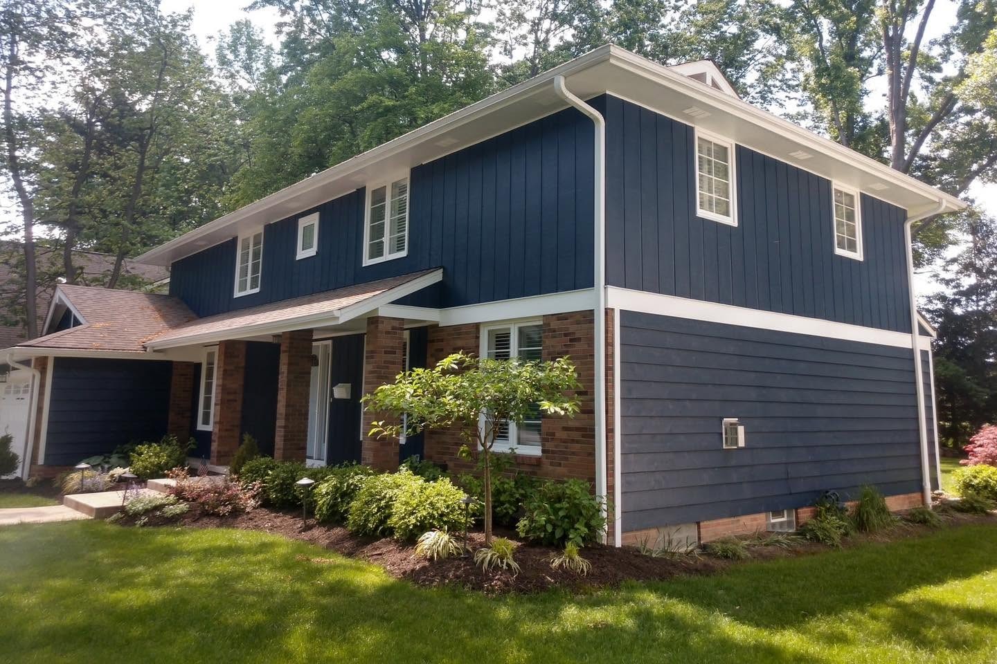 Completed navy and white residential exterior painted by Allure Painting