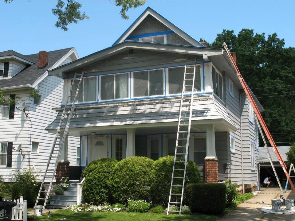 Light siding on a two-story home before refinishing