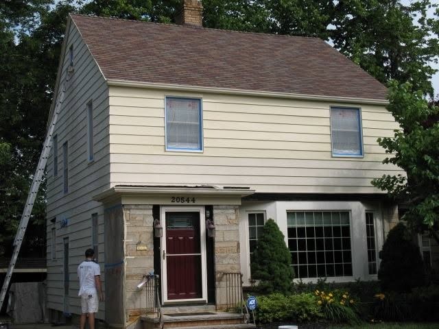 Light siding on a two-story home before refinishing