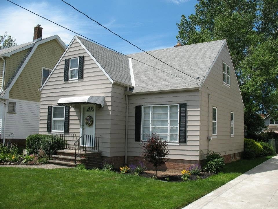 Light refinished siding on a gabled home after refinishing